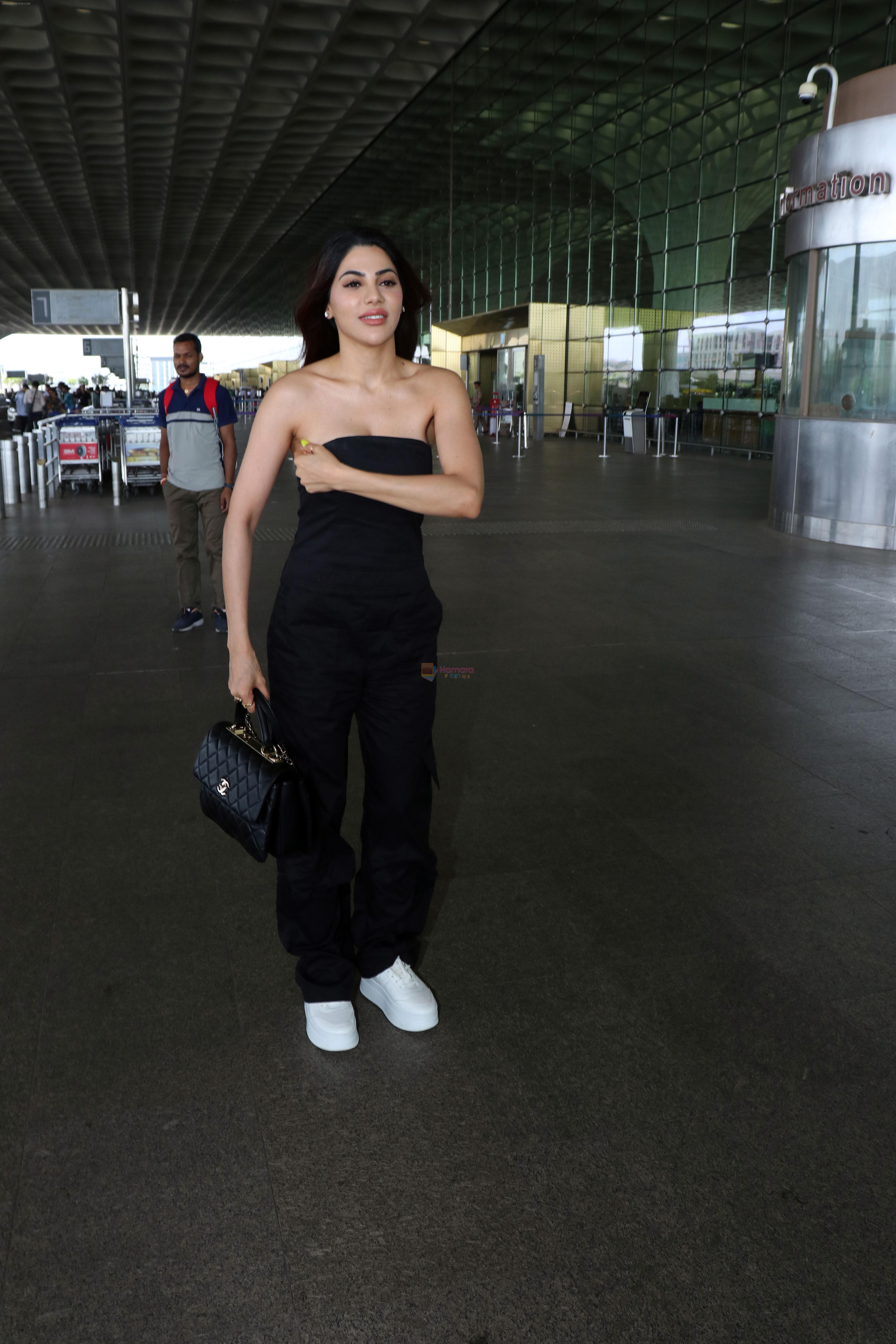 Nikki Tamboli wearing all black strapless bodycon dress, white sneakers